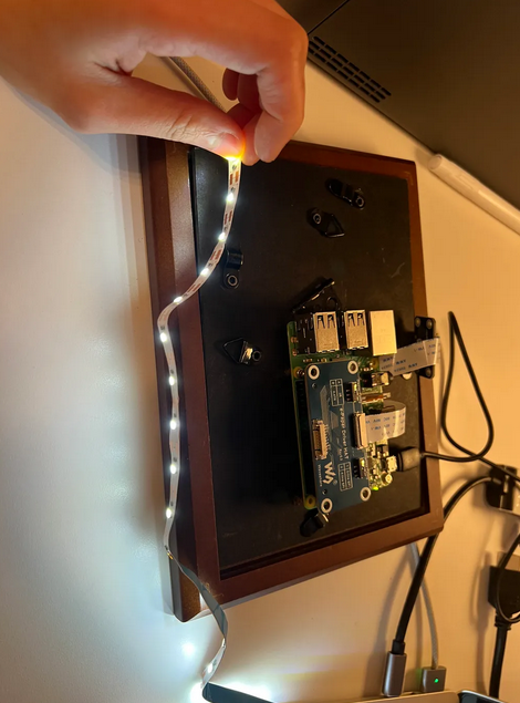The Raspberry Pi mounted to the back of the picture frame during assembly